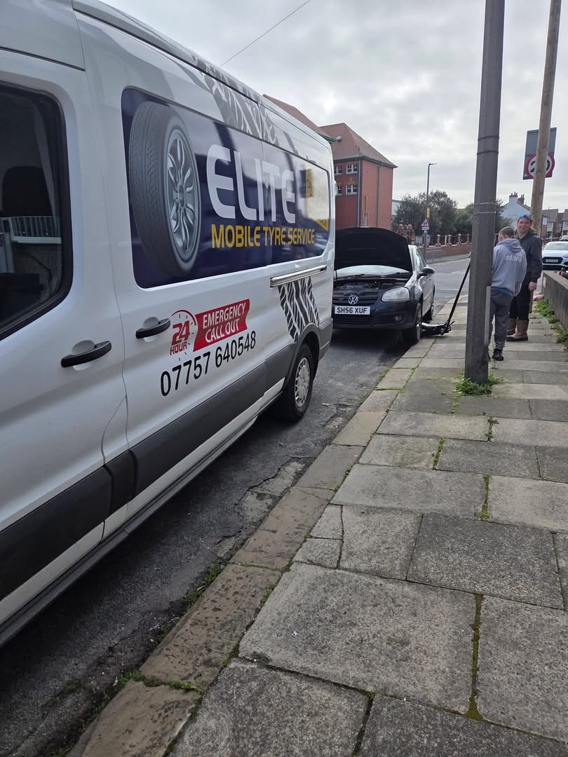 Roadside tyre fitting in Bradford — Elite Mobile Tyre Service van parked behind a black Volkswagen Golf while a technician fits a replacement tyre